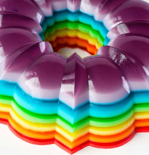 This Spiked Rainbow Ribbon Salad takes the classic layered gelatin and turns it into the life of the party by adding of your favorite flavored vodka or rum!