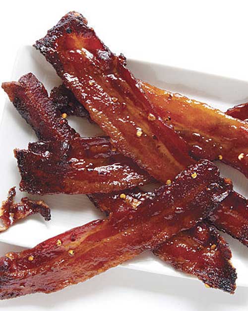 Recipe for Spicy Candied Bacon - What makes this the perfect Easter bacon? It’s like spicy bacon candy. It’s great on its own as an appetizer, chopped into a salad, or even on your Baked Beans!