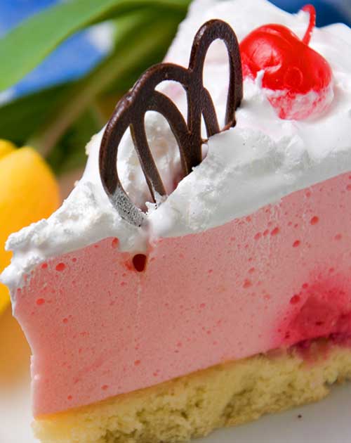A light and fluffy no bake Strawberry Cheesecake recipe, complete with a fancy chocolate garnish.