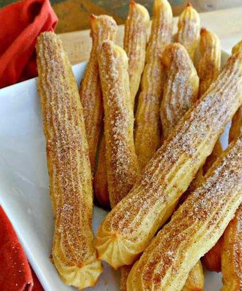 My Baked Cinnamon and Sugar Churros are a breeze to prepare and super fun to eat with your hands. Chewy on the inside and crisp on the outside, with a nice dusting of cinnamon and sugar to boot. The way a churro should be!