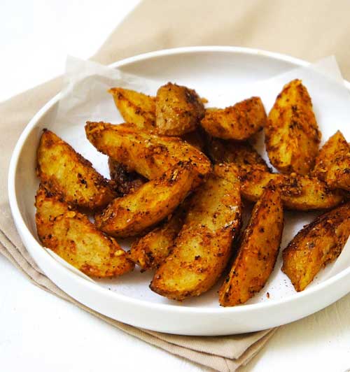 These oven baked Parmesan Potato Wedges are perfectly crisp and tasty. The potatoes are tossed together with Parmesan cheese before baking.