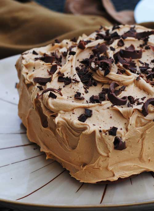 This Banana Chocolate Chip Cake with Peanut Butter Frosting is, at it’s core, is a very moist, rich banana bread, dressed up in peanut butter frosting.