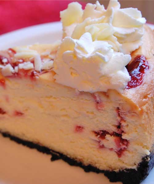 I like a rich cheesecake with nice height to it and I think a generous swirl of fresh whipped cream on top looks so nice. This Copycat Cheesecake Factory White Chocolate Raspberry Truffle Cheesecake recipe is both of those things!