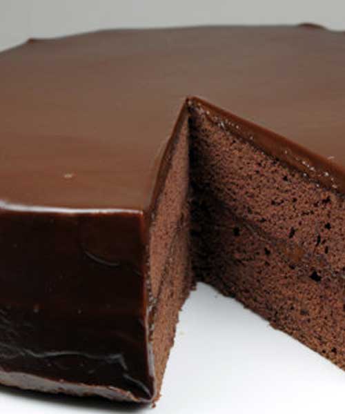 Recipe for Flourless Chocolate Cake with Chocolate Glaze - For devoted chocolate lovers' only! The ultimate chocolate indulgence, this moist and dense chocolate cake is topped with a smooth, rich dark chocolate ganache that melts in your mouth. Serve it with sweetened whipped cream and raspberries for a delightful and elegant desert.