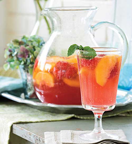 Recipe for Carolina Peach Sangria - Peaches put a Southern twist on this classic sparkling cocktail. Make the sangria the day before to allow the flavors to blend. Garnish with fresh mint.