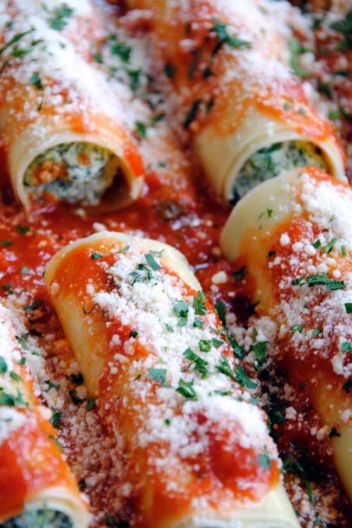 These Ricotta and Spinach Manicotti are filled with a blend of ricotta, mozzarella and fresh spinach then topped with a tomato basil sauce and Parmigiano-Reggiano for a cheesy, flavorful dish that will wow your dinner guests.