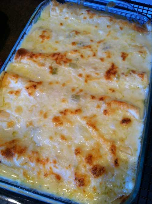 White Chicken Enchiladas with green chili sour cream sauce. It is seriously even better than it looks!