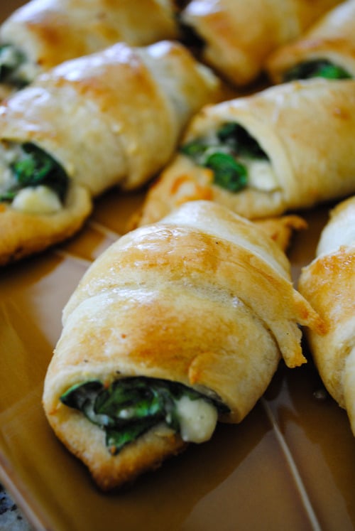 Melted cheese and spinach stuffed into a light and fluffy crescent roll! Not only are these cheesy spinach crescent rolls perfect for when you need dinner in a hurry, they also make the perfect snack or appetizer.
