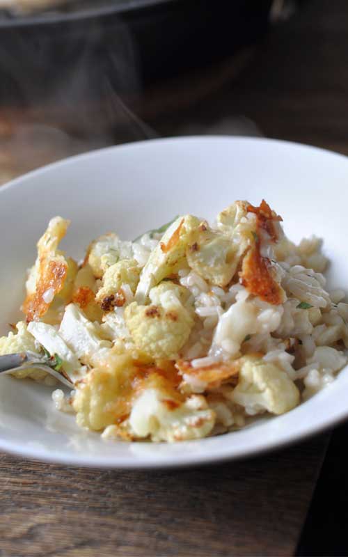This Roasted Cheesy Cauliflower Risotto has texture and flavor all rolled into one bubbling pan of arborio. Caramelised, cheesy bits in the roasted parts, and the soft, flavor-soaked bits care of the risotto.