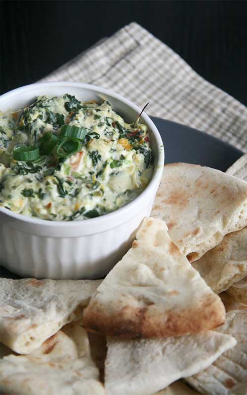 This Copycat Applebee's Spinach and Artichoke Dip is a delicious blend of mozzarella, parmesan, and romano cheeses, combined with spinach and artichoke.
