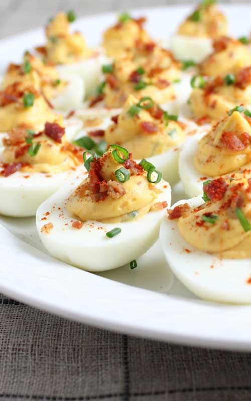 These yummy Smoky Deviled Bacon And Eggs went over so well at our summer cookouts, I started making them for holiday dinners as well. Everyone likes the addition of crumbled bacon.