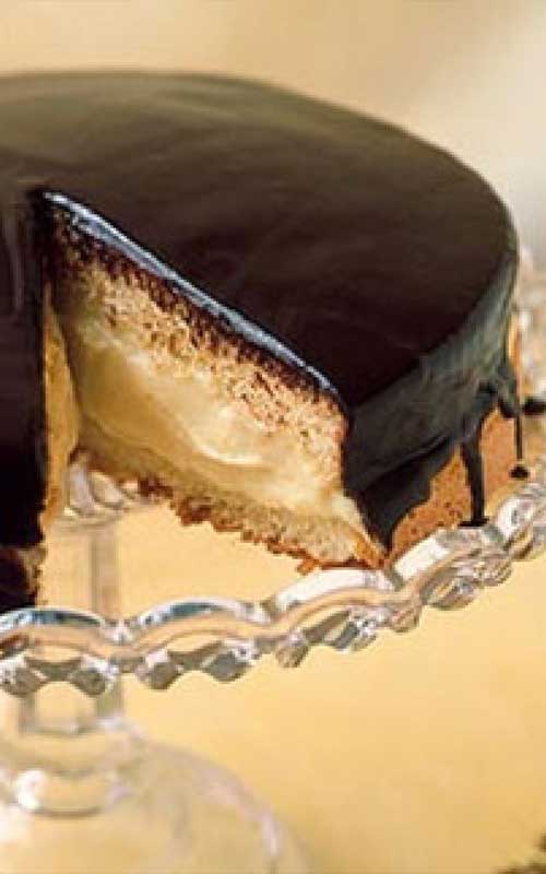 This American classic Boston Cream Pie, first made by a Boston chef in the 1850s, isn't actually a pie at all, it's a cake: two sponge layers with custard-cream filling and a shiny chocolate glaze.