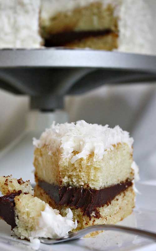 If you like chocolate and coconut together, you’re going love this Coconut Layer Cake with Chocolate Ganache Filling topped with Swiss meringue buttercream and coconut flakes!