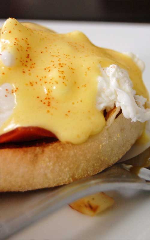 Hot buttered English muffins, Canadian-style bacon, and poached eggs are topped with a heavenly drizzle of hollandaise sauce. Breakfast does not get any better than a classic Eggs Benedict!