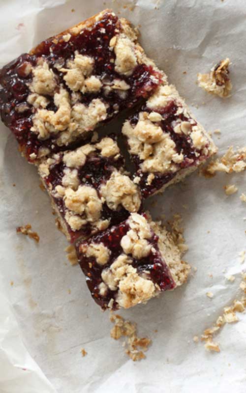 These Raspberry Oat Crumble Bars bake up into three layers of shortbread goodness, sweet raspberry, and buttery crumble. They taste like brown sugar and old-fashioned oats, with a healthy smear of jam oozing out the middle.