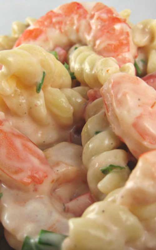When served on a bed of mixed greens, this shrimp Louis pasta salad makes a great luncheon or light supper meal.