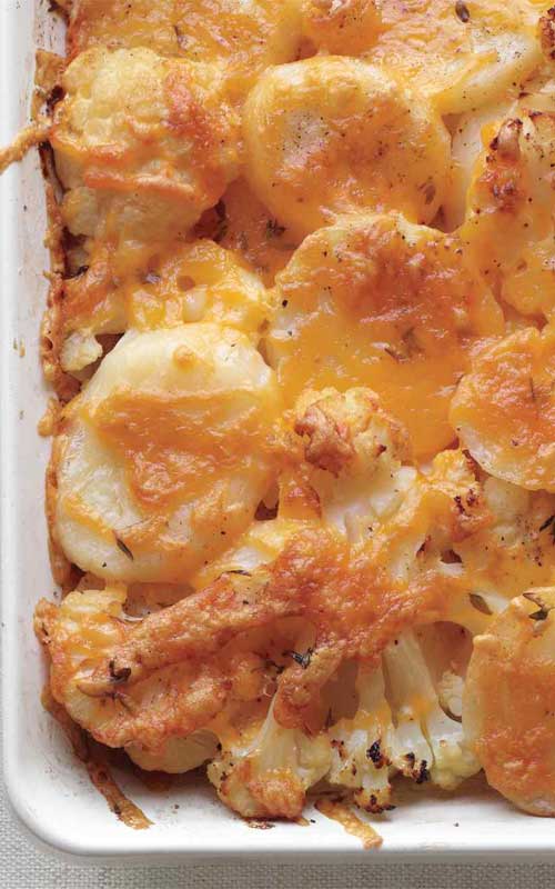 Adding cauliflower to a potato bake may seem crazy, but it adds great texture to this Potato, Cauliflower, and Cheddar Bake. A cheesy topping is a nice change of pace from the usual creamy casserole too.