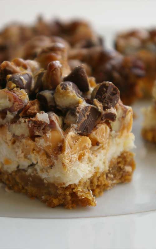 Recipe for Dolly Bars - Also known as Magic Bars or Seven Layer Cookies, these gooey, sweet treats combine all the good stuff: coconut, chocolate chips, pecans, and a graham cracker cookie base.
