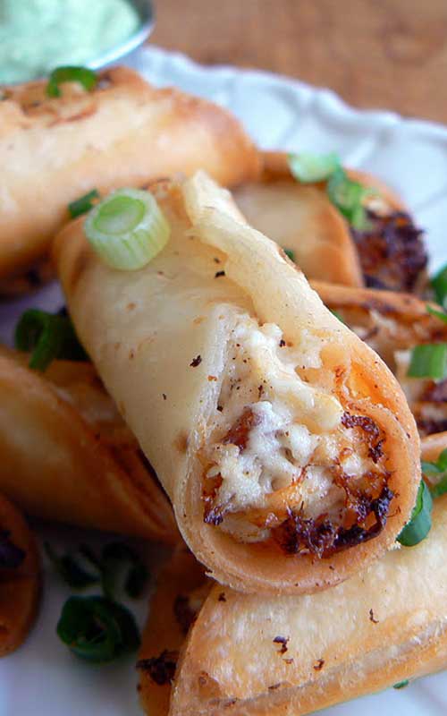 Recipe for Chicken and Bacon Mini Taquitos - These delectable appetizers take a little bit of work, but are so worth it. Served with a tasty avocado sauce, they'll disappear as soon as they come out of the pan!