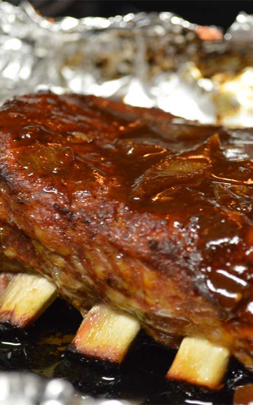 Recipe for Sweet & Sticky BBQ Ribs - It's really easy to get the low and slow smokehouse flavors of these Sweet & Sticky BBQ Ribs at home. With a spice rub, some time, and BBQ sauce, you will be devouring the best ribs in town.