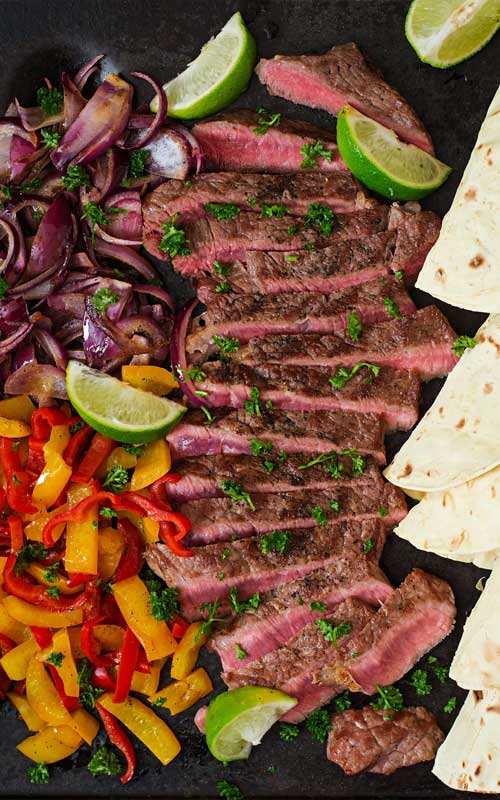 Enjoy your own Tex-Mex feast at home with this super-easy recipe for Margarita Steak Fajitas! Tequila and fresh lime juice are part of a marinade that gives these steak fajitas their bright flavor.
