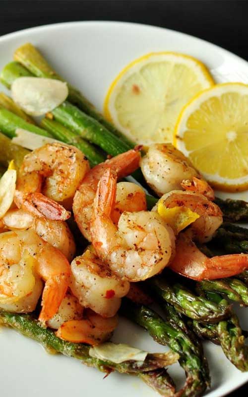 This Lemon and Garlic Shrimp Over Asparagus is an easy, quick, and healthy entree that is cooked in one pan and can be on your table in under 25 minutes.